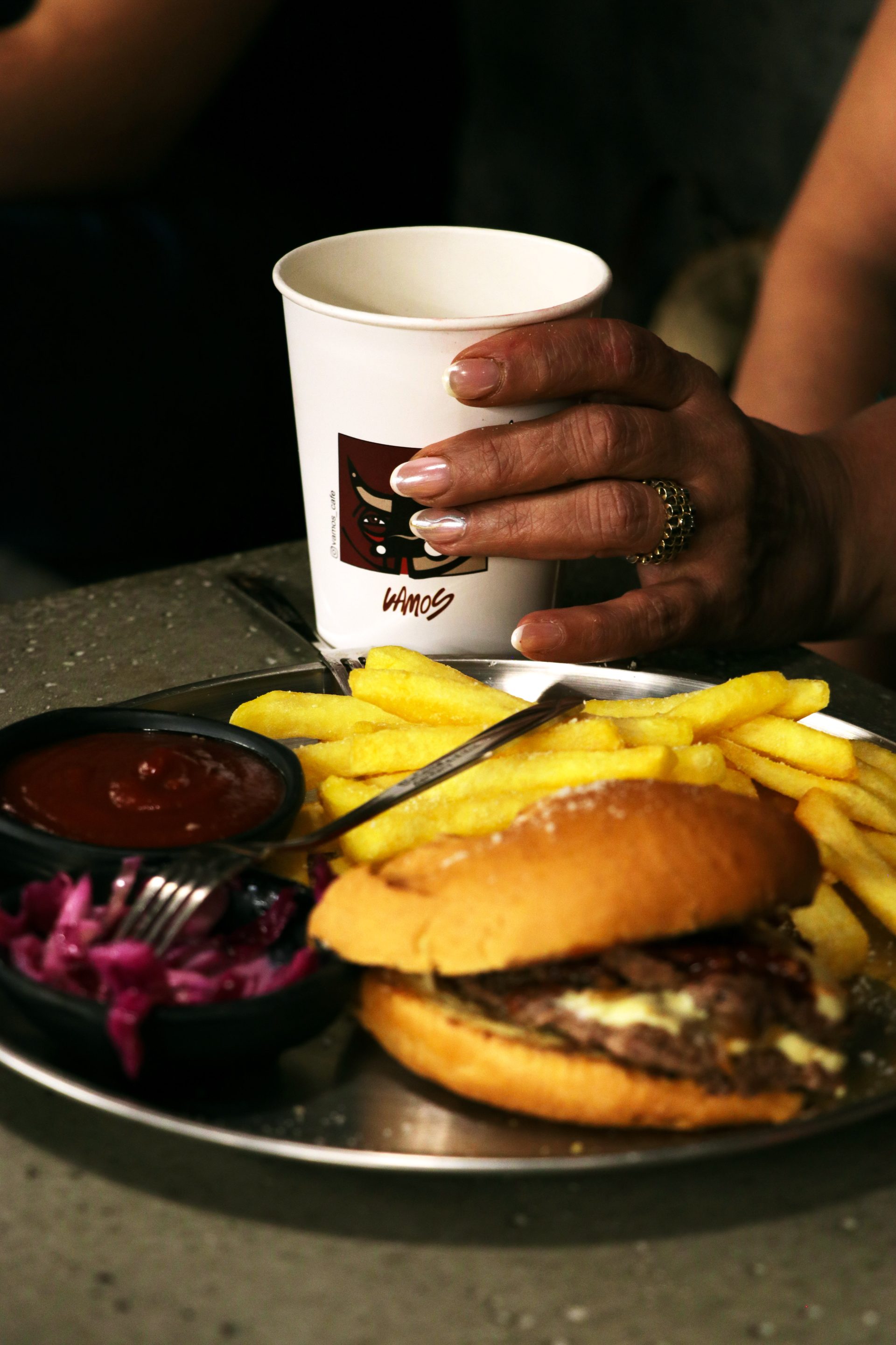 Burger and fries with a Vamos-branded cup